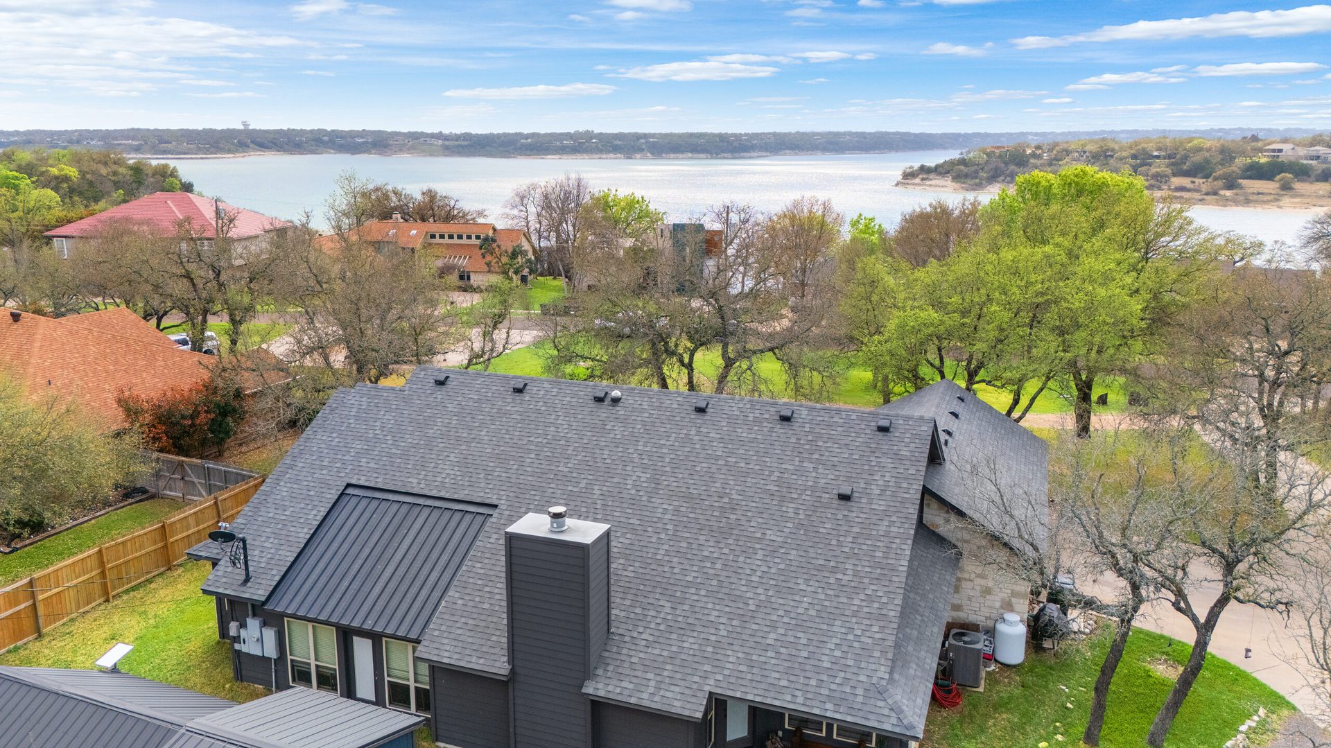 Aerial view over Lake Travis waterfront homes captured on a shoot day
