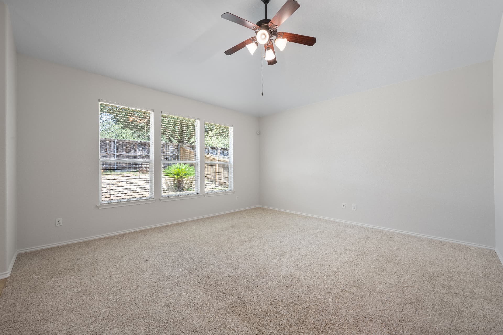 Empty carpeted living room before virtual staging