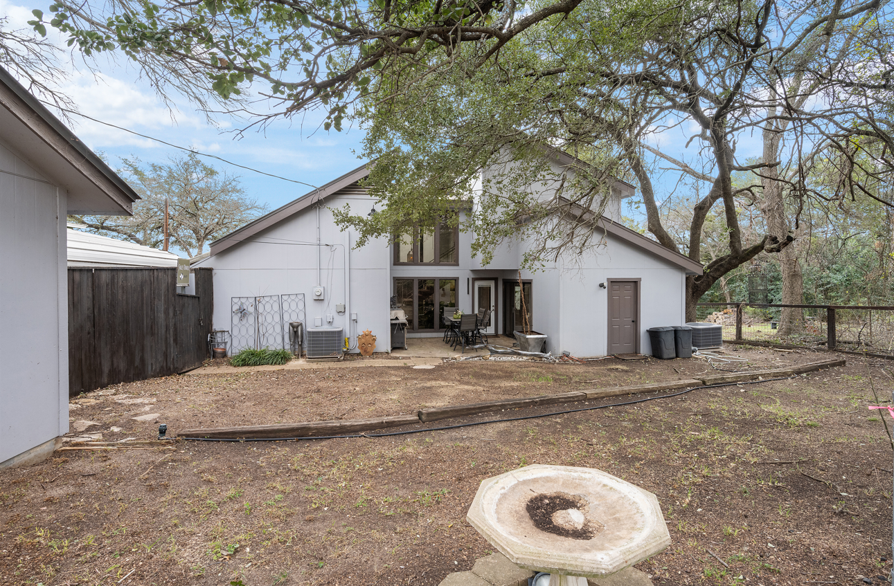Backyard exterior with patchy dirt lawn before editing